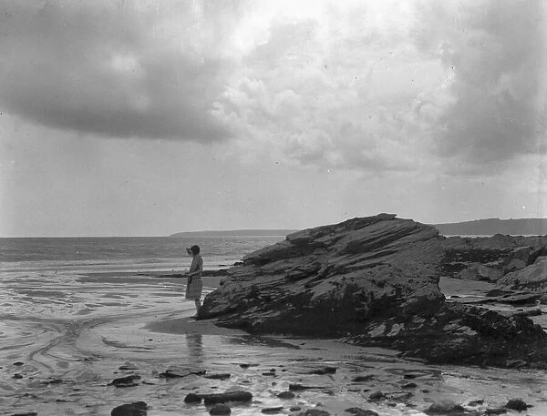 A young girl seen here on the beach near Par, Cornwall. August 1927 132a