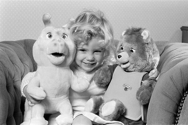 A young girl with soft toys, left a Teddy Ruxpin toy. 21st October 1986