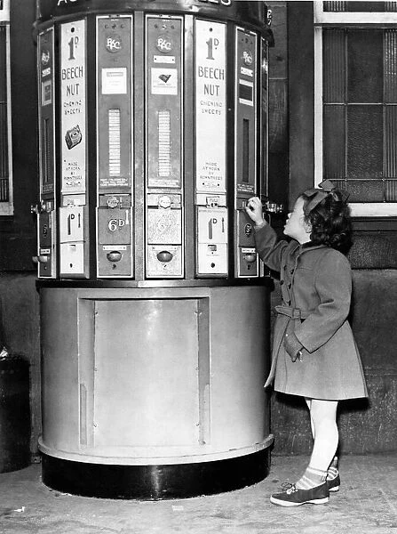A young girl at a vending machine on Newcastle Central Station in 1954