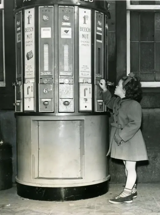 Framed Print : A young girl at a vending machine on Newcastle Central Station in 1954