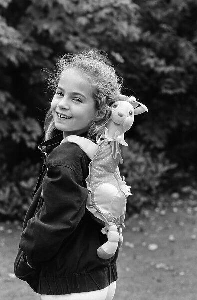 A young girl wearing a soft toy rucksack. 21st October 1986