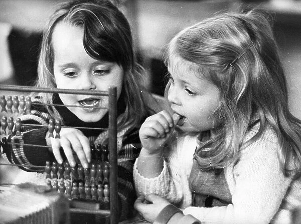 These young girls learn the art of calculating with the help of a abacus