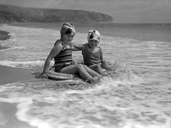 Two young girls in the sea at Swanage, Dorset. July 1933