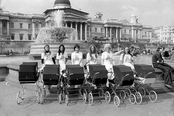 Six young ladies pushing prams on a sunny day in Trafalgar Square