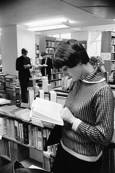 Young lady reading a text book in the Technical book department at Foyles bookshop in