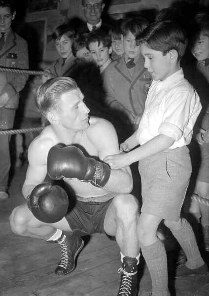 This young man is learning how to fight from a professional boxer. 1949