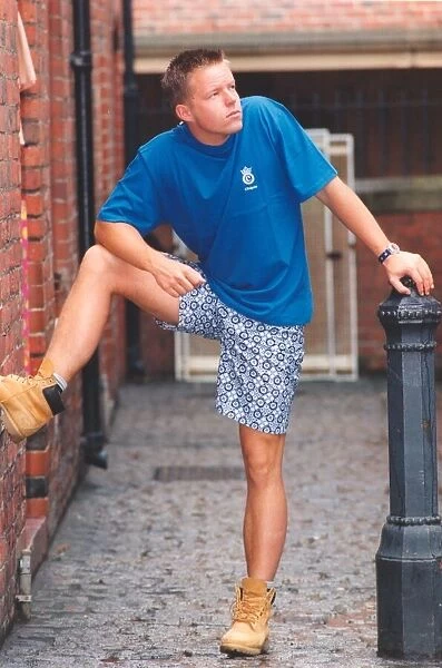 A young man posing in the latest summer wear and shorts - not always ideal for