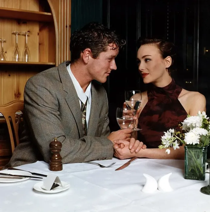 Framed Print : Young man and woman holding hands at dinner table looking into each others eyes Framed Print : Young man and woman holding hands at dinner table looking into each others eyes