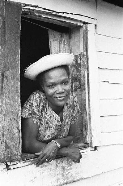A young Maroon woman poses for the camera in her home in St Elizabeth