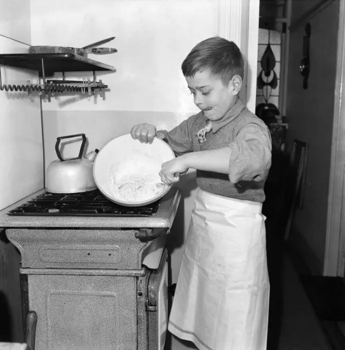 Framed Print : A young mixing ingredients together in a bowl in his kitchen at home. December 1952 C6055 Framed Print : A young mixing ingredients together in a bowl in his kitchen at home. December 1952 C6055