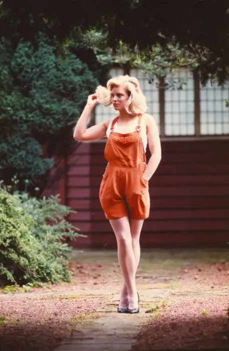 Framed Print : A young model poses in the latest Dungarees and high heels