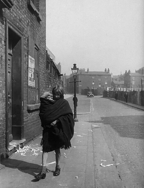 Young mother carries her child in a shawl, Liverpool. 3rd April 1939