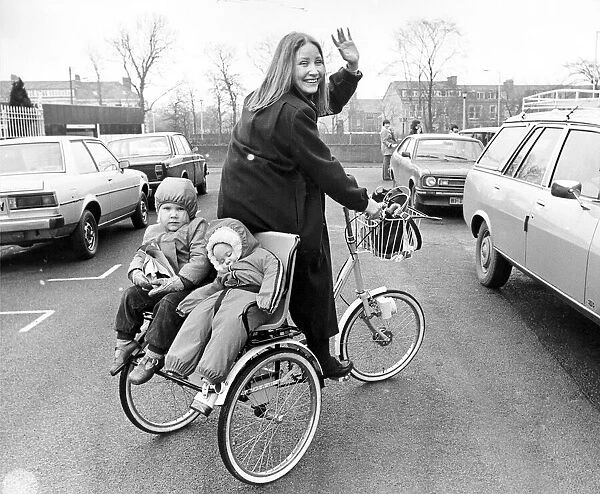 Young mum Vivien Simpson transports her two toddlers around on a chair fitted to the back