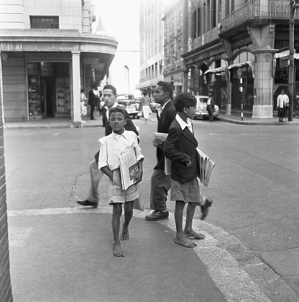 Young newspaper vendors on the streets of Cape Town selling copies of the Cape Argus