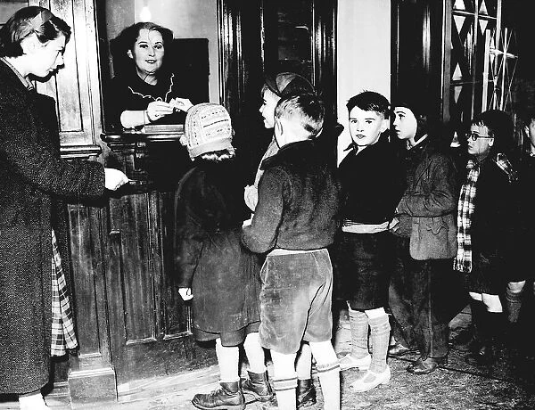 Young patrons queue up at the desk, pay their money for the matinee showing on a Saturday