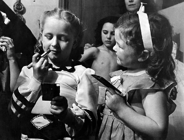 Two young performers seen here making themselves up before the performance of the Easter