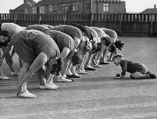 The young Peter Downer looks for his mother during an exercise class held for mothers at