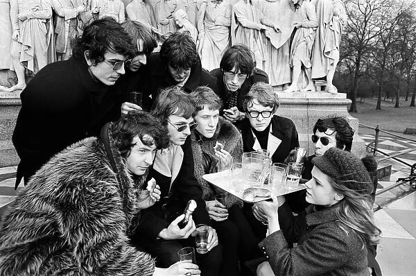 Young pop stars gathered at the Albert Memorial in London for a bread and water lunch to draw attention to Oxfams Christmas appeal. Pictured, Elaine Osborn serving bread and water to (left to right back row) Syd Barrett, Barry Fantoni, Gordon Waller