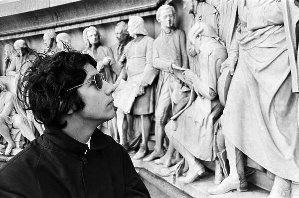 Young pop stars gathered at the Albert Memorial in London for a bread and water lunch to draw attention to Oxfams Christmas appeal. Pictured, Cat Stevens looking at the frieze encircling the podium of the Albert Memorial. 8th December 1966