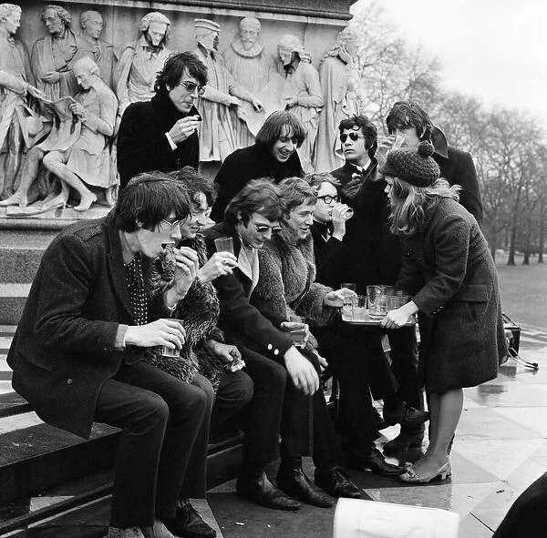 Young pop stars gathered at the Albert Memorial in London for a bread and water lunch to draw attention to Oxfams Christmas appeal. Pictured, Elaine Osborn serving bread and water to Roger Waters, Nick Mason, Syd Barrett, Rick Wright, Barry Fantoni