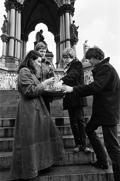 Young pop stars gathered at the Albert Memorial in London for a bread and water lunch to draw attention to Oxfam's Christmas appeal. Pictured (left to right), Sue Pulford, a production assistant with Oxfam, serving bread and water to Paul Jones