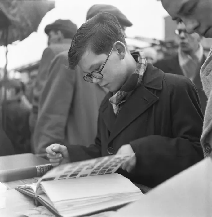 Framed Print : A young stamp collector looking to add to his collection at the flea market in Club Row Framed Print : A young stamp collector looking to add to his collection at the flea market in Club Row