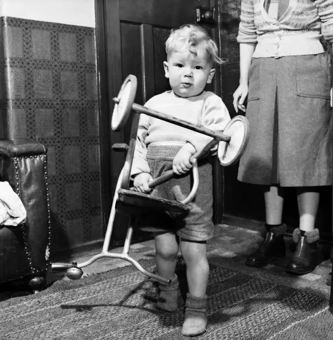 Framed Print : Young toddler boy holding a tricycle upside down December 1952 C6391-003 Framed Print : Young toddler boy holding a tricycle upside down December 1952 C6391-003