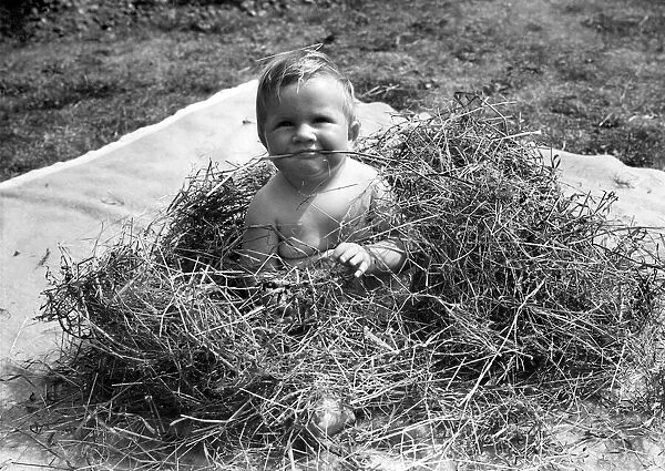 Young toddler playing in the back garden oh his home in Erith, Kent
