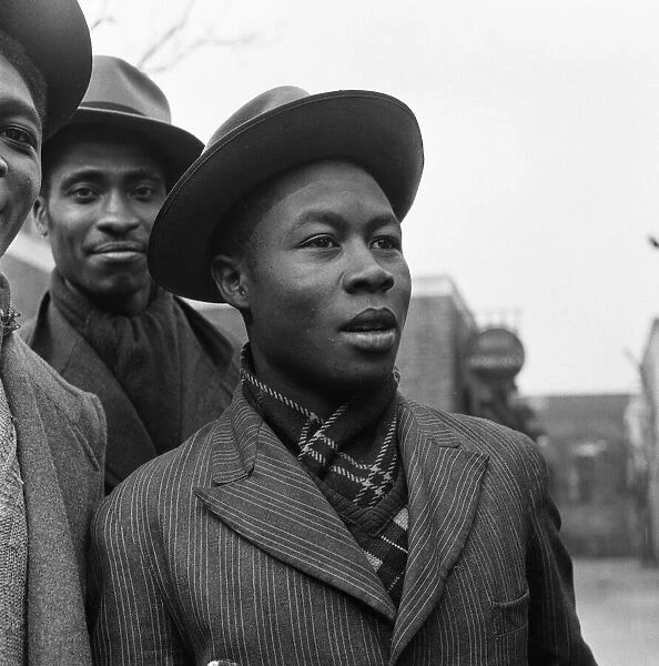 Young West Indian men standing outside the Brixton Labour Exchange looking for employment