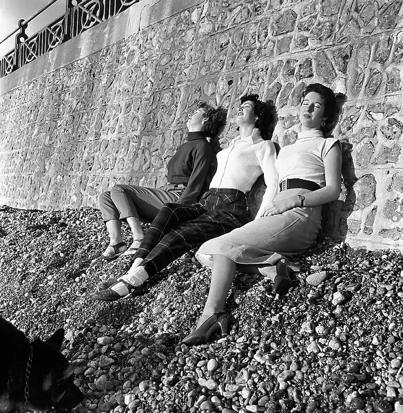 Three young women enjoy the winter sun, Brighton, East Sussex