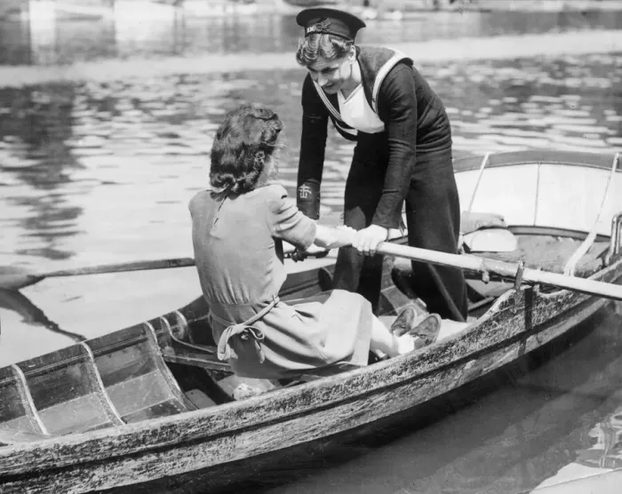 Framed Print : Two young women in a rowing boat, one in Naval uniform, on holiday. 20th May 1945 Framed Print : Two young women in a rowing boat, one in Naval uniform, on holiday. 20th May 1945