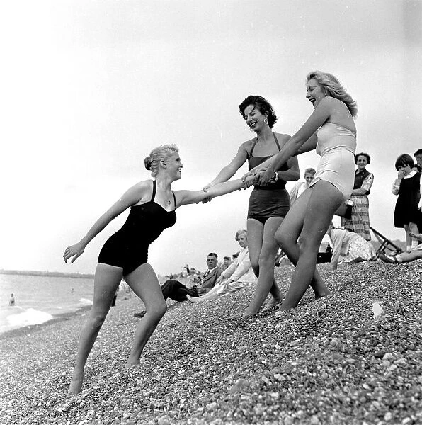 Three young women in their swimsuits at Hastings. 5th August 1958