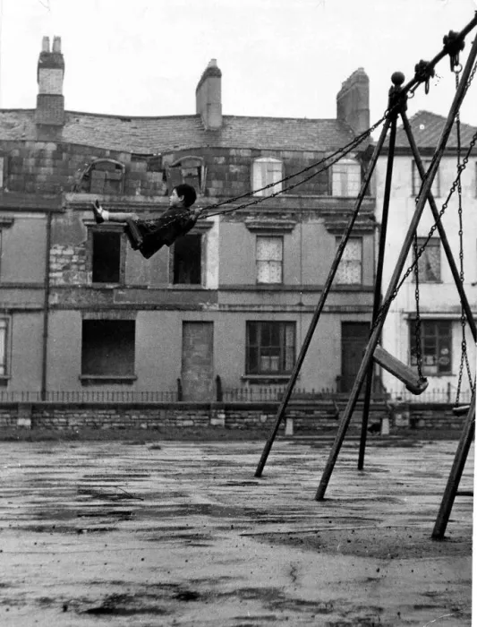 Framed Print : A youngster enjoys the swing in a playground in the docks of Butetown in Cardiff Framed Print : A youngster enjoys the swing in a playground in the docks of Butetown in Cardiff