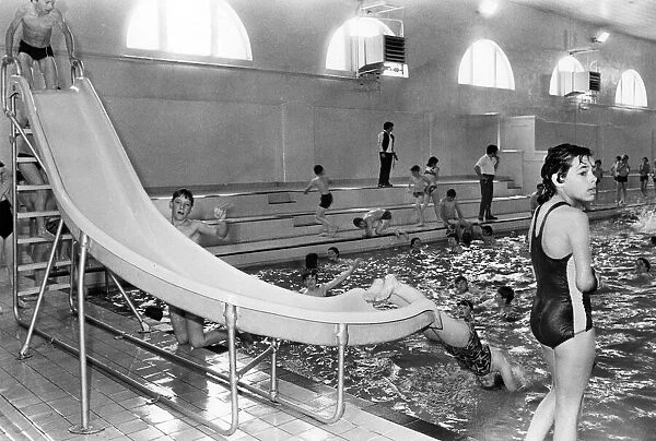 Youngsters enjoy a quick slide to swimming at the new look Wallsend baths. 28th July 1980