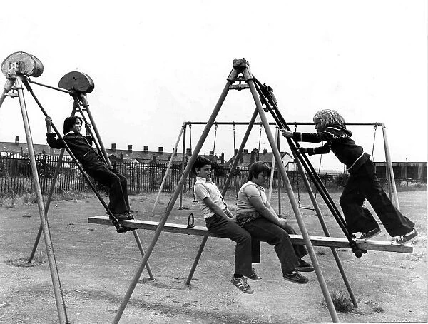 Four youngsters enjoying the Summer sunshine at a play area in the Cardiff docks area