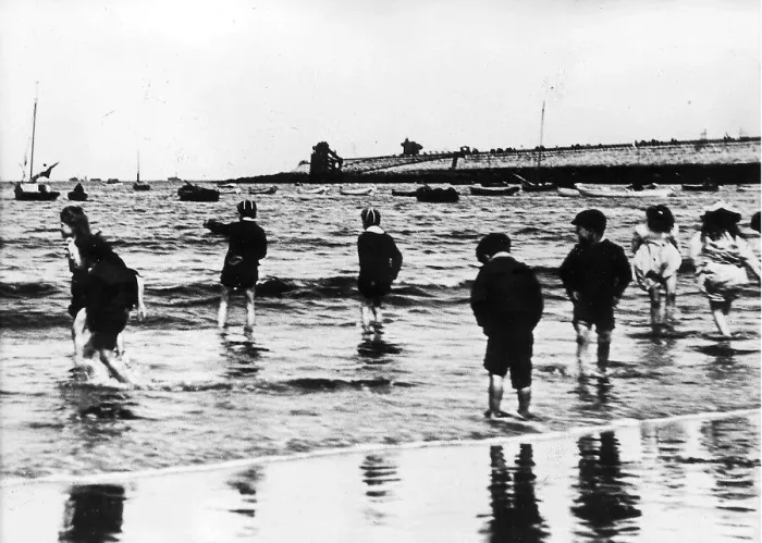 Framed Print : Youngsters paddling in the sea