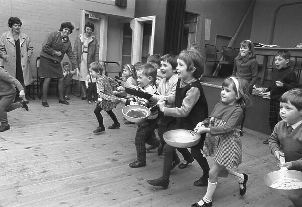 Youngsters take part in a pancake race at Styvechale Young Wives Club in Coventry