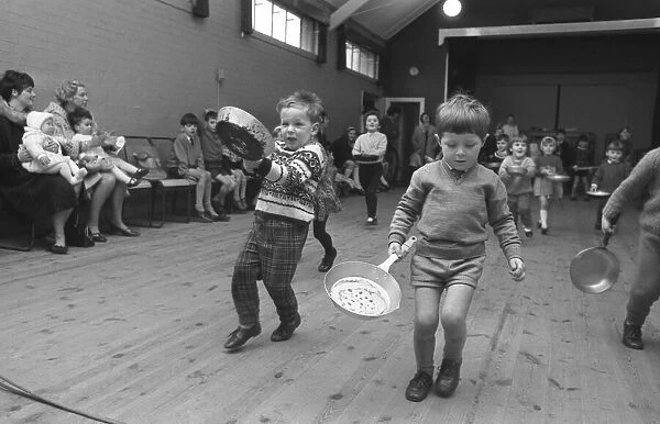 Youngsters take part in a pancake race at Styvechale Young Wives Club in Coventry