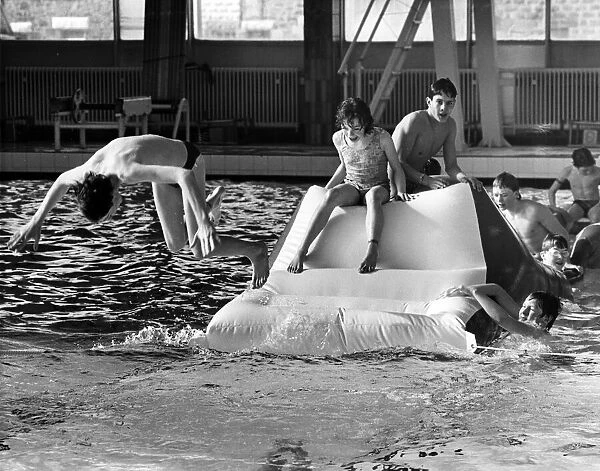 Youngsters tackle the inflatable assault course at Stanley Baths. 8th March 1986