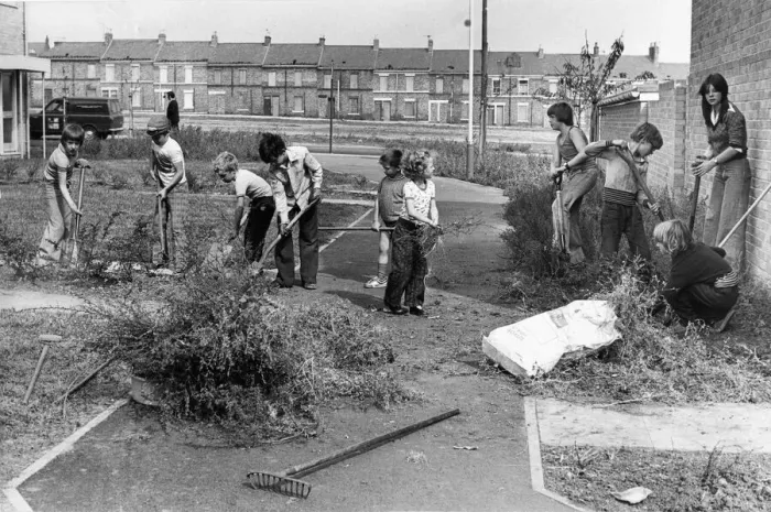Framed Print : Youngsters take part in a volunteer clean-up of their community in a part of Framed Print : Youngsters take part in a volunteer clean-up of their community in a part of