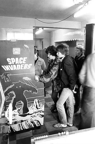 Youths play on a Space Invaders machine in Newcastle in December 1980