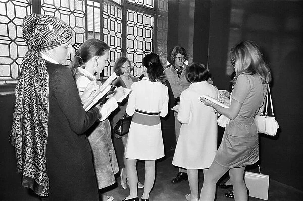 Yves Saint Laurent, designer, pictured speaking with journalists at the opening of his