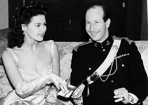Yvonne De Carlo accepting cigarette from case actress Ninth Earl of Lanesborough