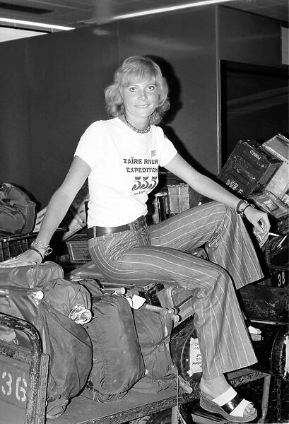 Zaire River Expedition Returns: Nurse Pam Baxter sitting on her luggage at Gatwick