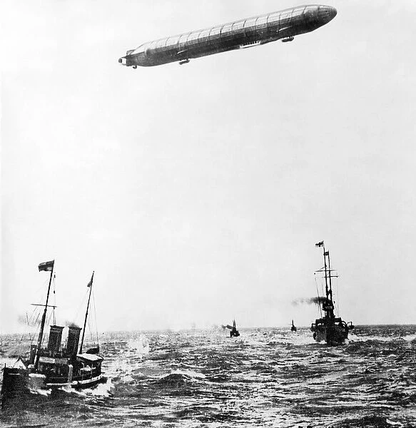 The Zeppelin airship flying over a battleship in the ocean during World War One
