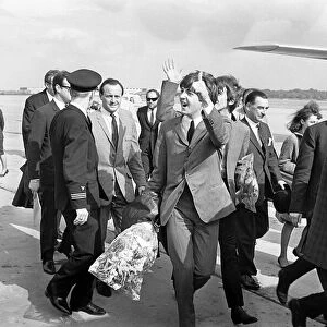 10 July 1964 Paul McCartneywaves to fans as The Beatles arrive at Liverpool airport
