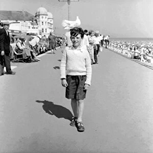 10 year old Alan Barker with a friendly pigeon on his head as he walks along