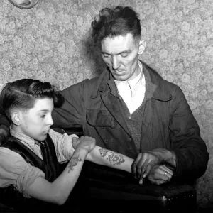 14-year-old Arthur Waterworth of Droylsden shows off his tattooed forearms to his father 14-year-old Arthur Waterworth of Droylsden shows off his tattooed forearms to his father