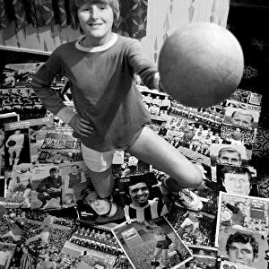 14-year-old Susan Lee surrounded by pictures of her favourite soccer stars wearing her