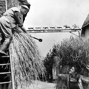 Joyce and Father Re-thatch Barley Village, 1944 Print